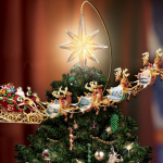 Thomas Kinkade does it again with a Revolving Christmas Tree Topper that goes over the top, literally